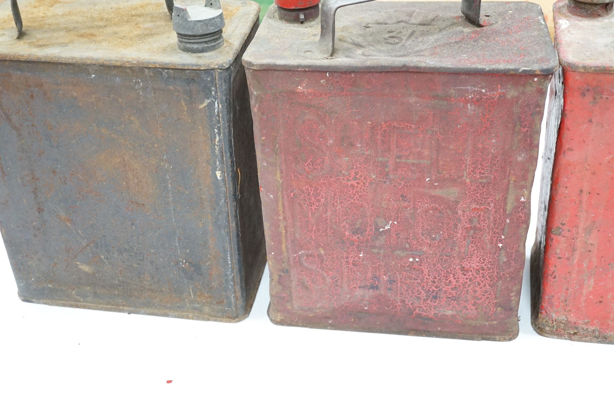 Three various petrol cans